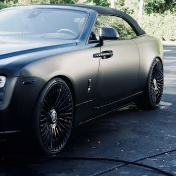Matte black Rolls-Royce parked outdoors