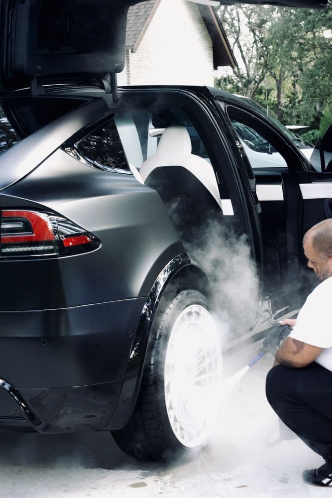 Revival Steam Detailing cleaning a black vehicle with steam